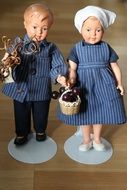 Dolls of a boy and a girl in striped clothes