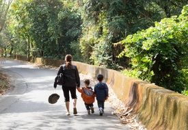 mother with children walks along the forest in China