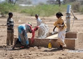 women and children at a water source in Ethiopia