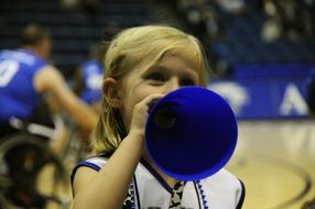 little cheerleader girl at a basketball game