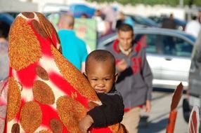 mother holding baby on the streets of morocco