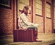 Child with luggage on a railway station