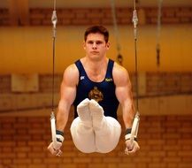 man performs on the rings in gymnastics