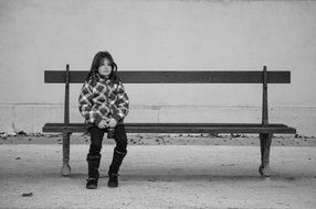 Black and white photo of the sitting girl