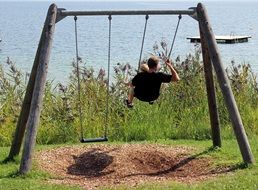 baby with father on swing