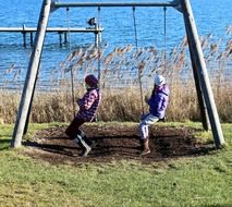 children ride on a swing