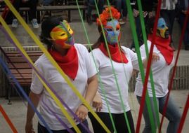 a group of girls in masks at the festival