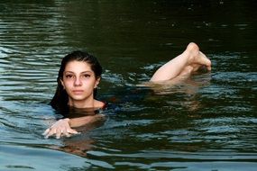 Girl swims like a mermaid in the water