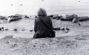 person sitting alone monochrome photo