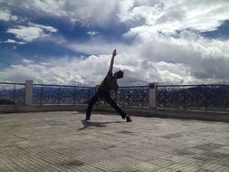 young man is doing yoga outside in India