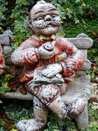 man stone statue in a garden