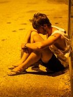 man sitting and sad on the street