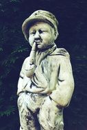 sculpture of a boy with a pipe