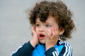 curly-haired boy with blue eyes
