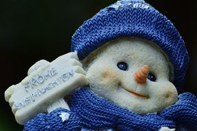 funny snowman in blue hat