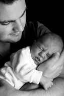 black and white a photo of the Pope with the baby