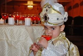 cute kid drink from a glass