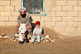 daughter with father near the house in Afghanistan