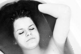 black and white photo of a girl in the bath