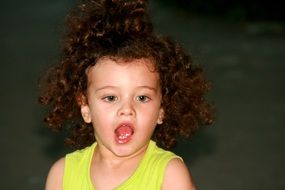 curly-haired child with an open mouth