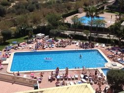 panoramic view of the pool at the resort on a sunny day