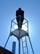 person on lookout tower, silhouette