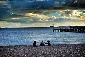 people relax on the beach with stones