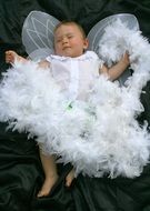 toddler in an angel costume with wings