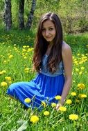 girl in the field with dandelions