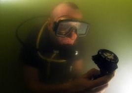 diver under dark water close up
