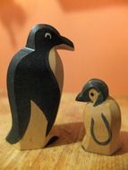 mother penguin and her baby is made of wood