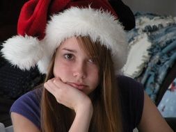 bored girl in santa claus hat