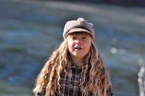 girl with long blond hair on a background of water