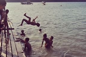 teenagers jump into the sea