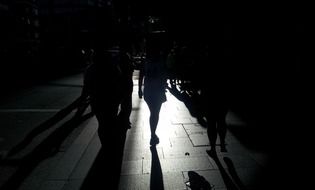 Silhouettes of people on a walk at night