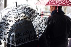 people with umbrellas on the street