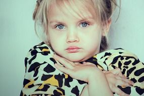 portrait of a beautiful thoughtful little girl