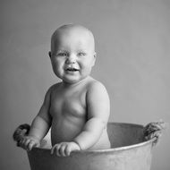 baby in iron bucket