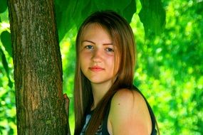 portrait of a girl with blond hair on a background of tree