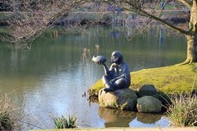 an old man and fish the statue have lake