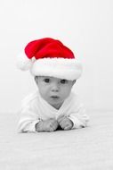 baby in santa clause's hat