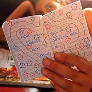 Girl holds her diary in hands