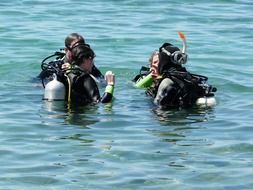 group of divers checking water in sea