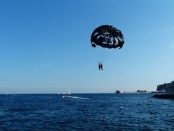 skydiver over blue water