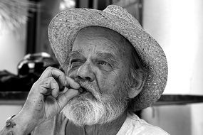 old man portrait cigar beard hat white and black color photo