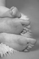 black and white photo of family feet