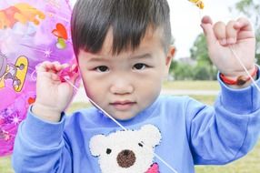 asian child with balloon outdoor, china, nanjing