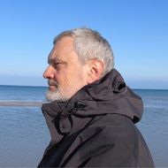 portrait of a gray-haired man on the background of the sea