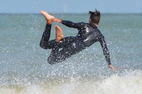 surfer jumping into water
