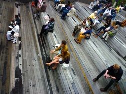 people on a wooden bench in the street
